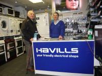 Lion Ron Webb with Clifford Hamstead from Havills work together to supply cooker to local resident